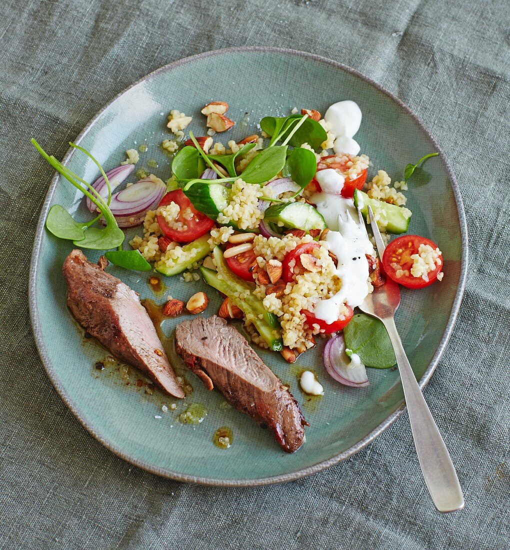 Spicy lamb fillet with bulgur salad and purslane