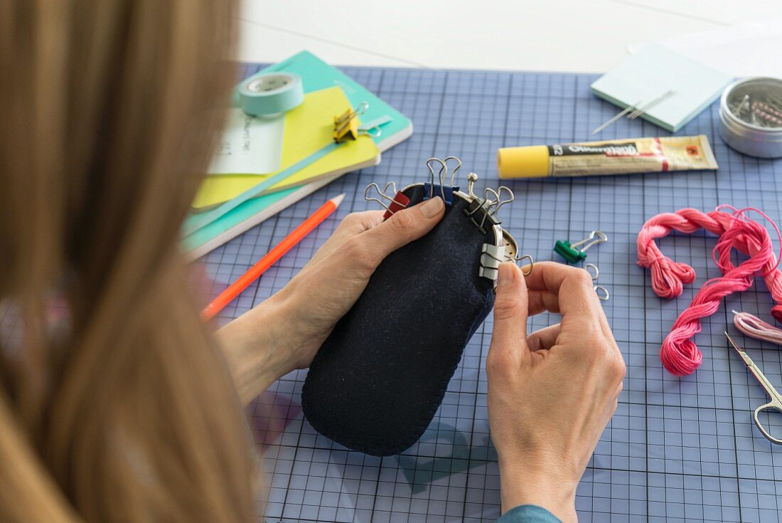 A purse frame being attached to a glasses case