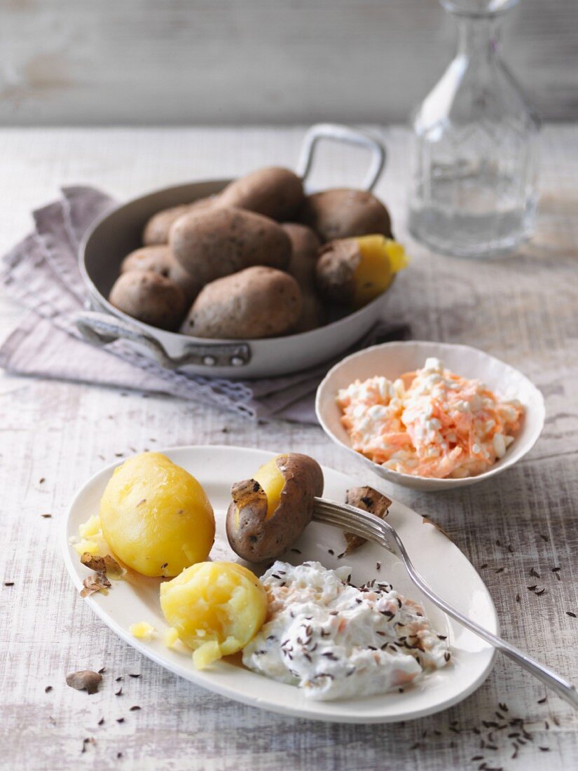 New potatoes with a carrot dip and cheese cream