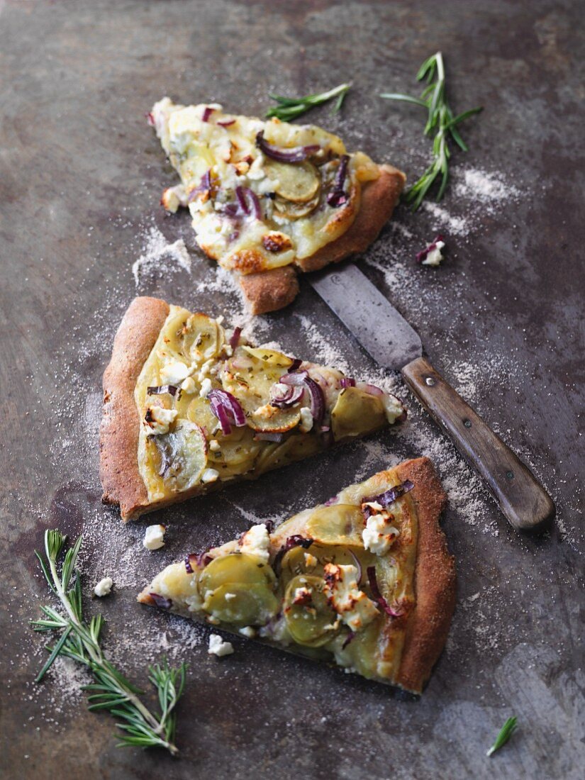 Vegetarian potato pizza with red onions, feta cheese and rosemary