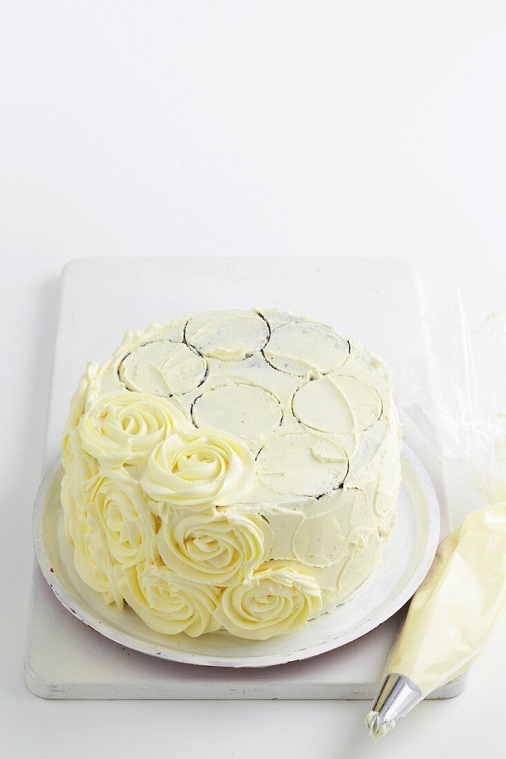 Garnish a black and white tart with white buttercream roses