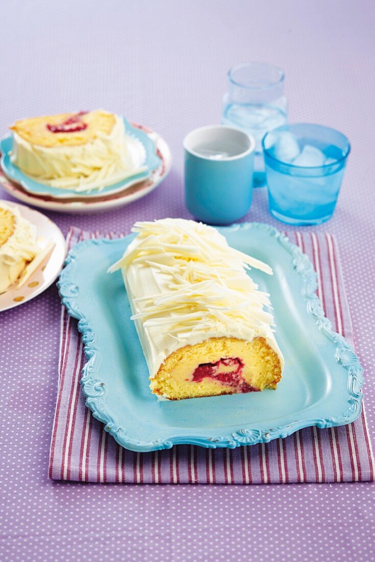 Sponge cake roll with white chocolate and raspberries