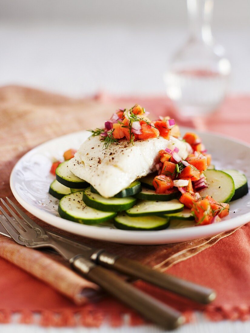 Cod fillet with papaya salsa on zucchini slices
