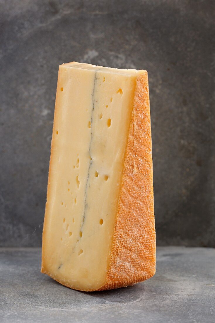 A slice of French Morbier cheese