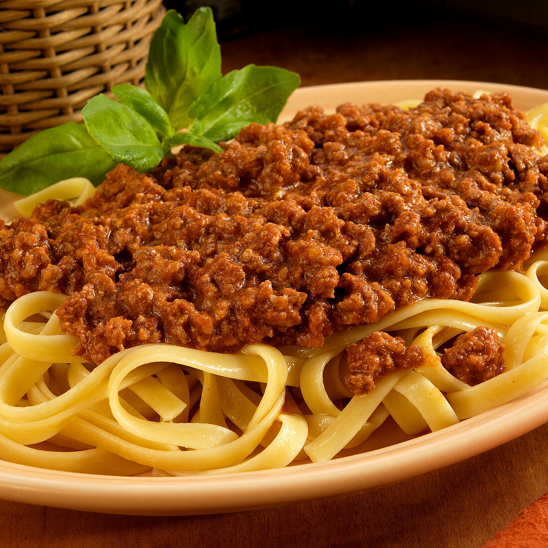 Tagliatelle with a minced meat sauce garnished with basil