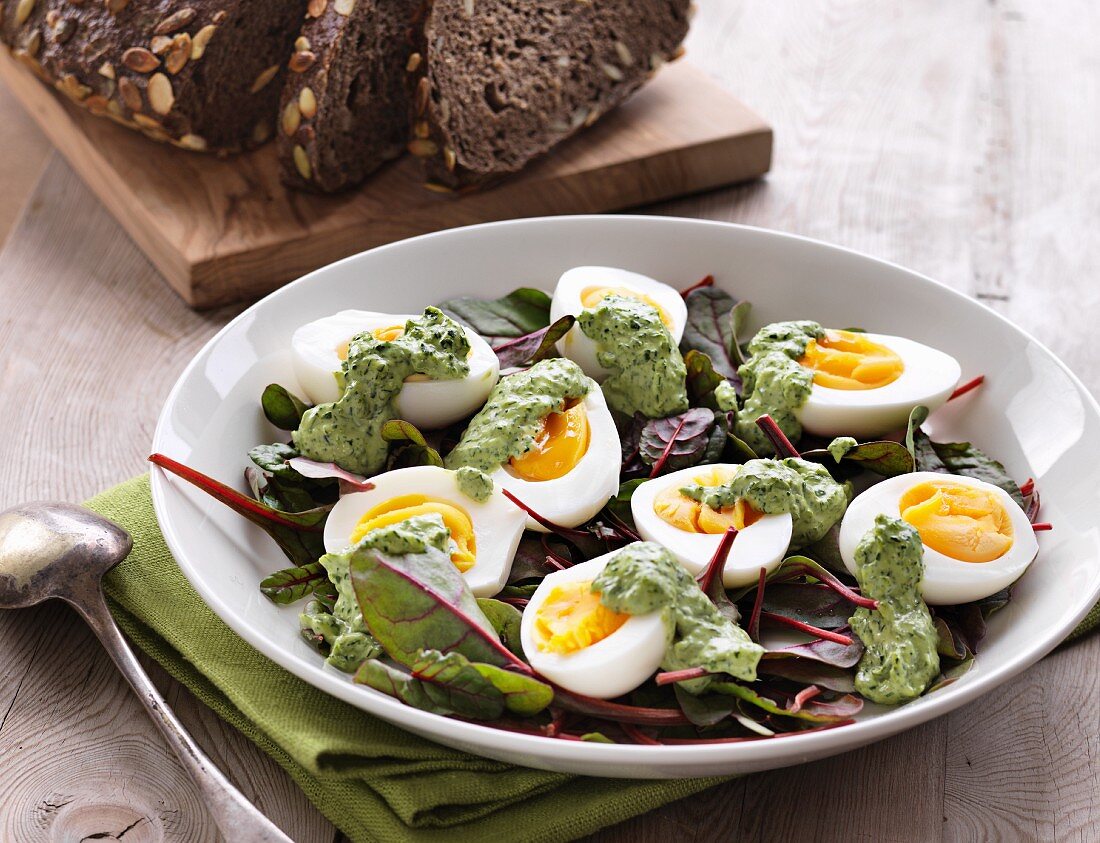 Boiled eggs with herb mayonnaise on lettuce