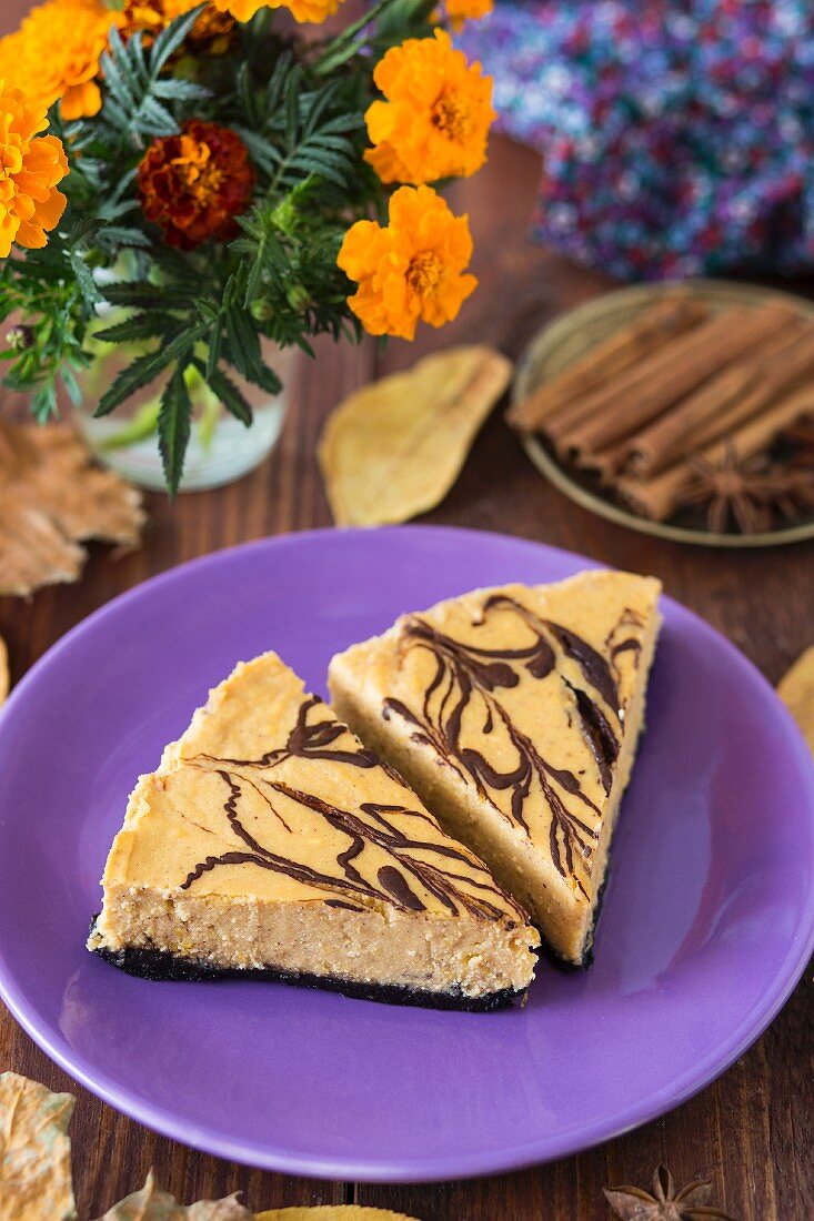 Two slices of pumpkin cheesecake with chocolate