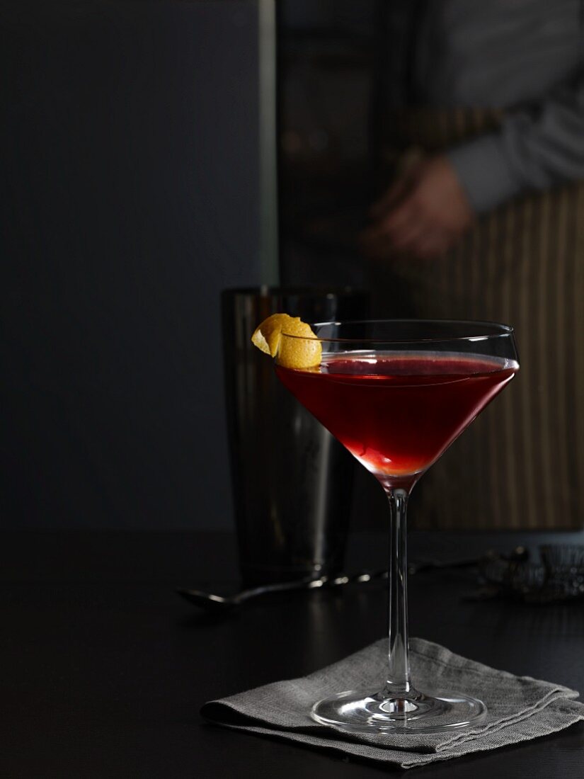 Capitan cocktail with sour cherries and lemon zest