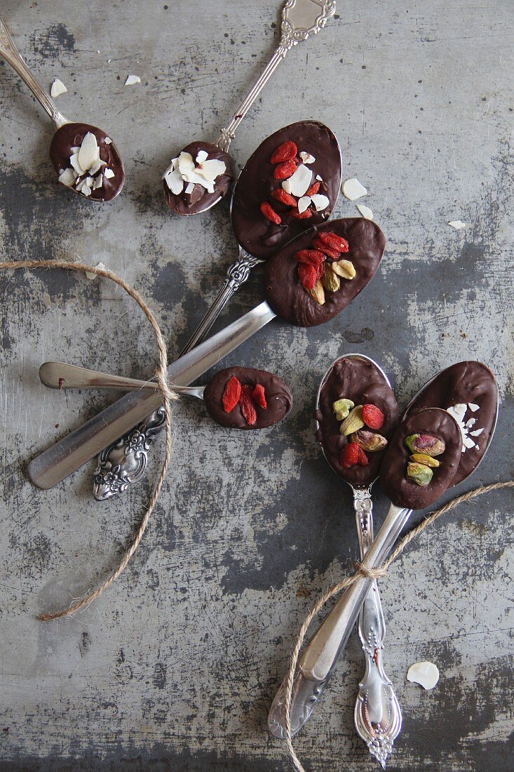 Spoons of chocolate, goaded berries and nuts