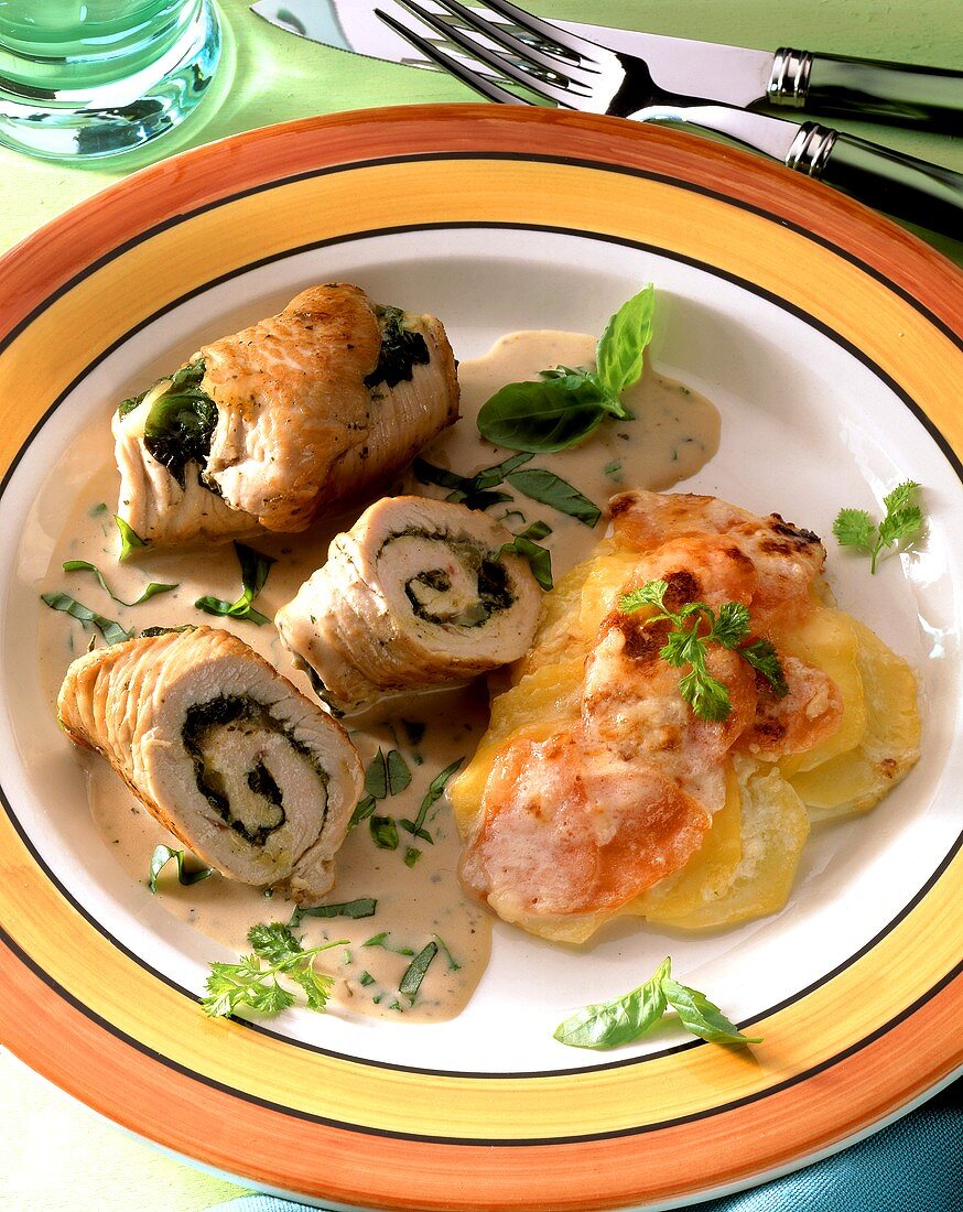 Turkey roll with spinach; potato and carrot gratin