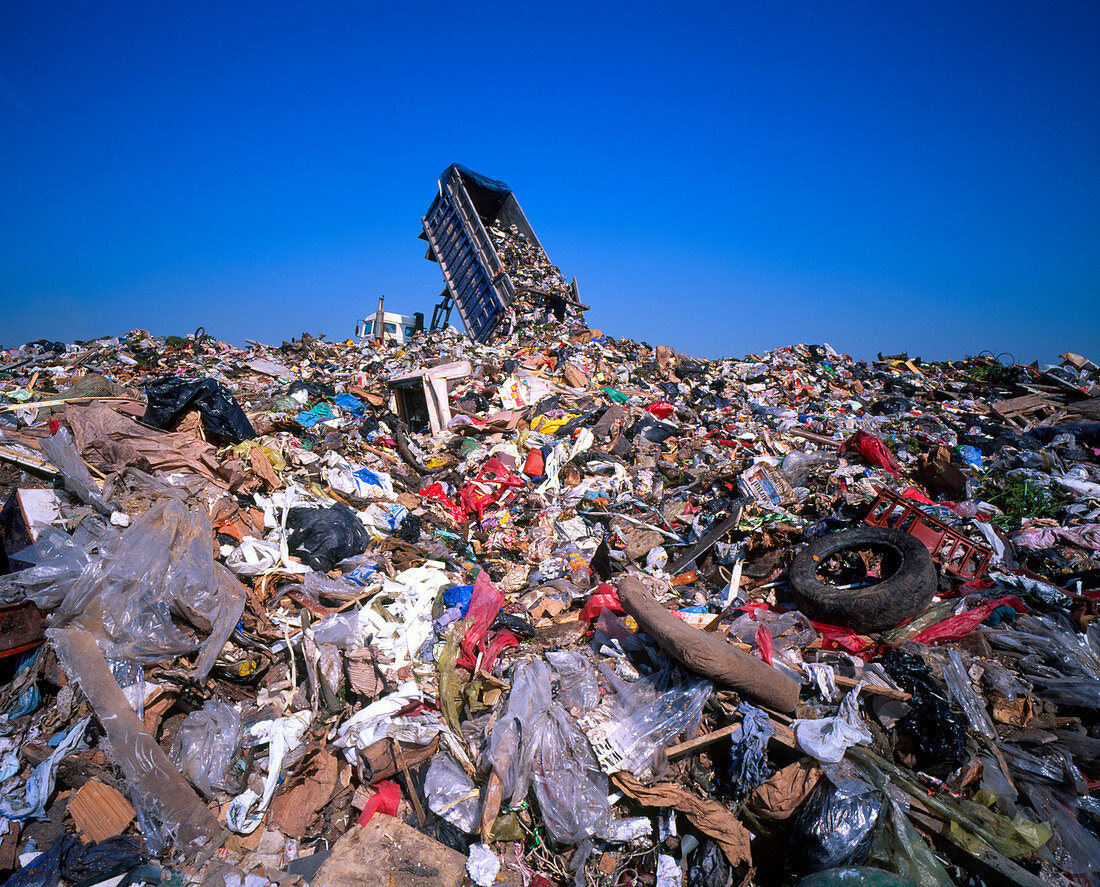 Landfill site with waste truck dumping refuse