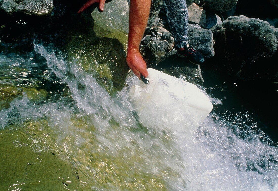 Sampling river water to test radiation levels
