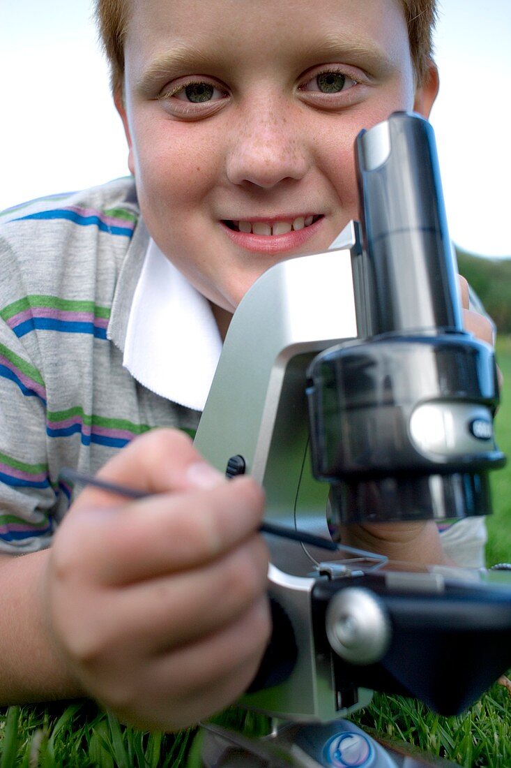 Boy using a light microscope