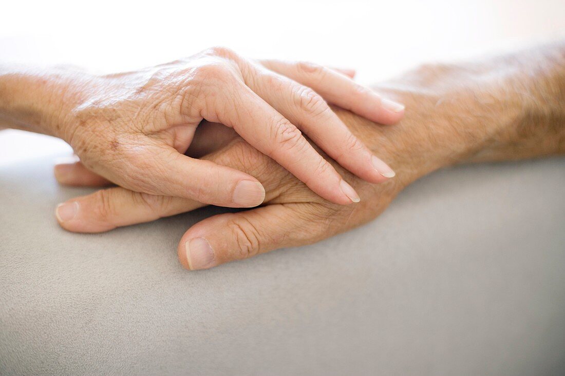 Senior couple holding hands