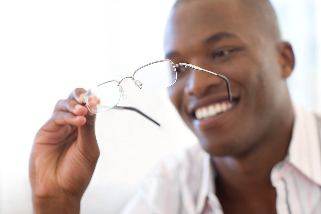 Man holding a pair of glasses