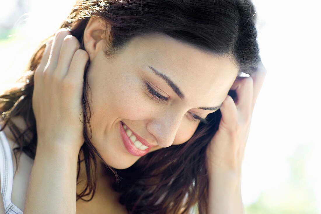 Happy woman holding her hair back