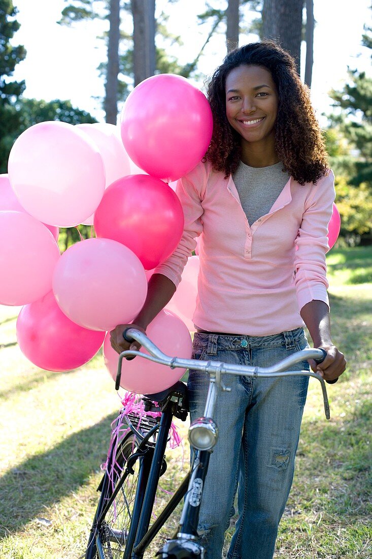 Woman with a bicycle and balloons