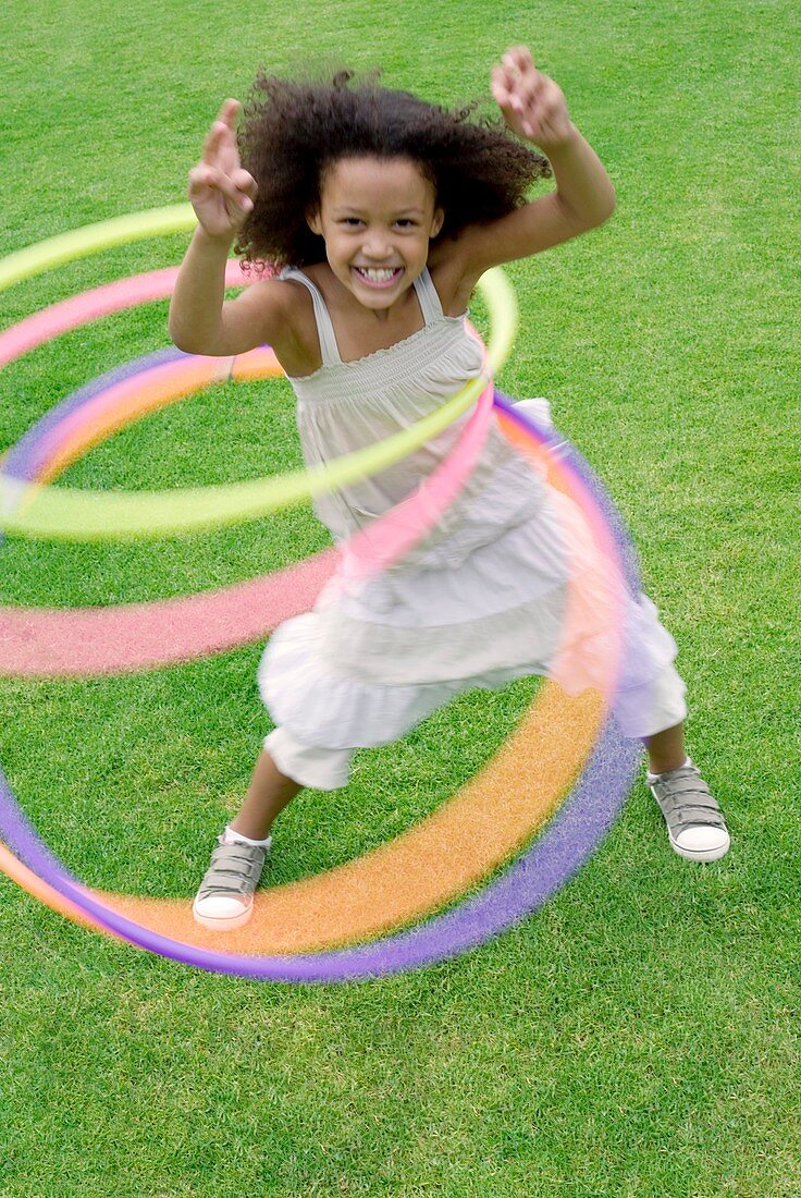 Girl playing with hula hoops