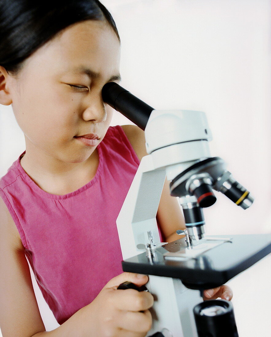 Girl using a microscope