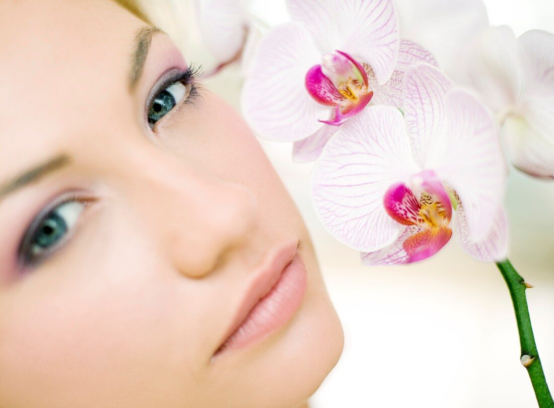 Woman smelling orchid flowers