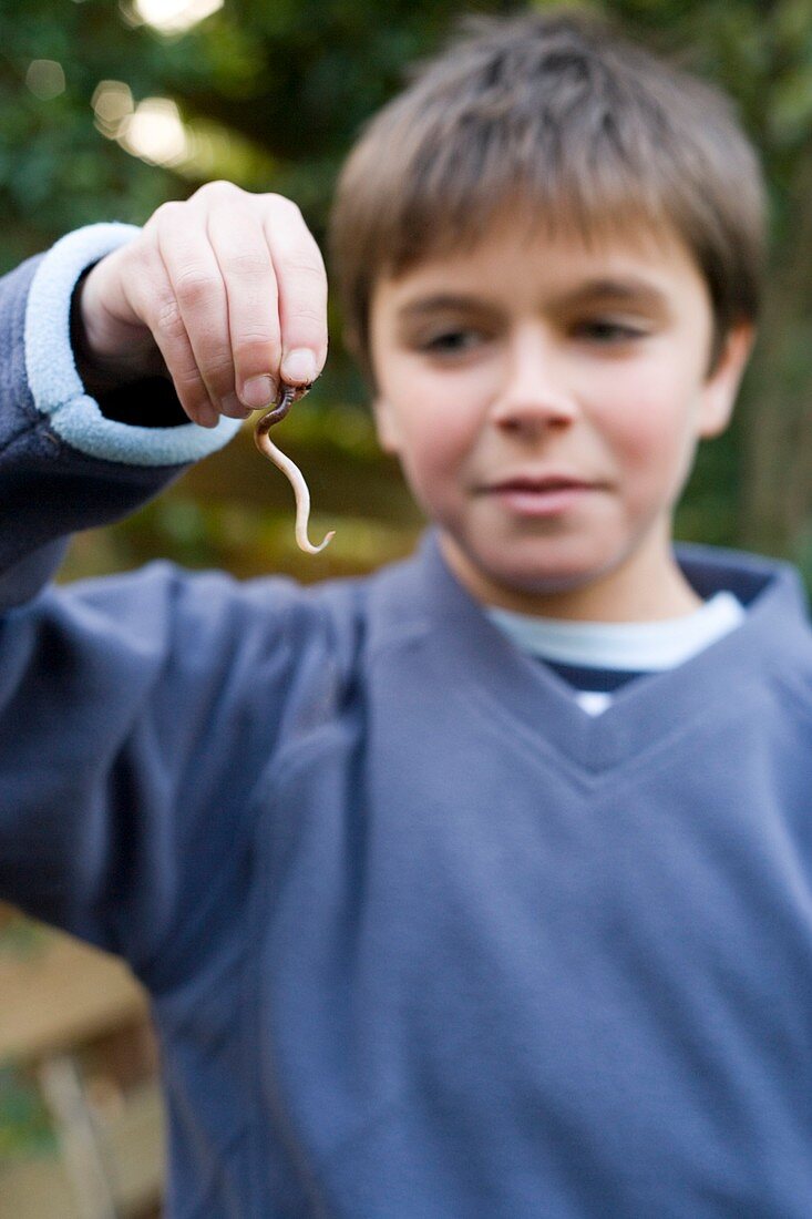Boy holding an earthworm