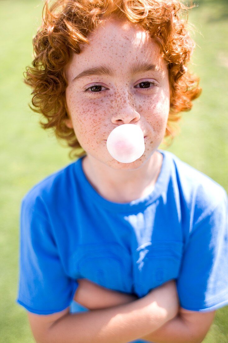 Boy blowing bubblegum