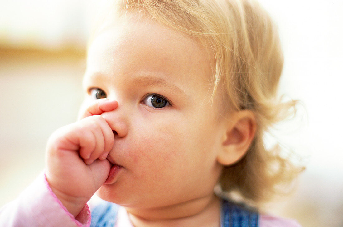 Young girl sucking her thumb