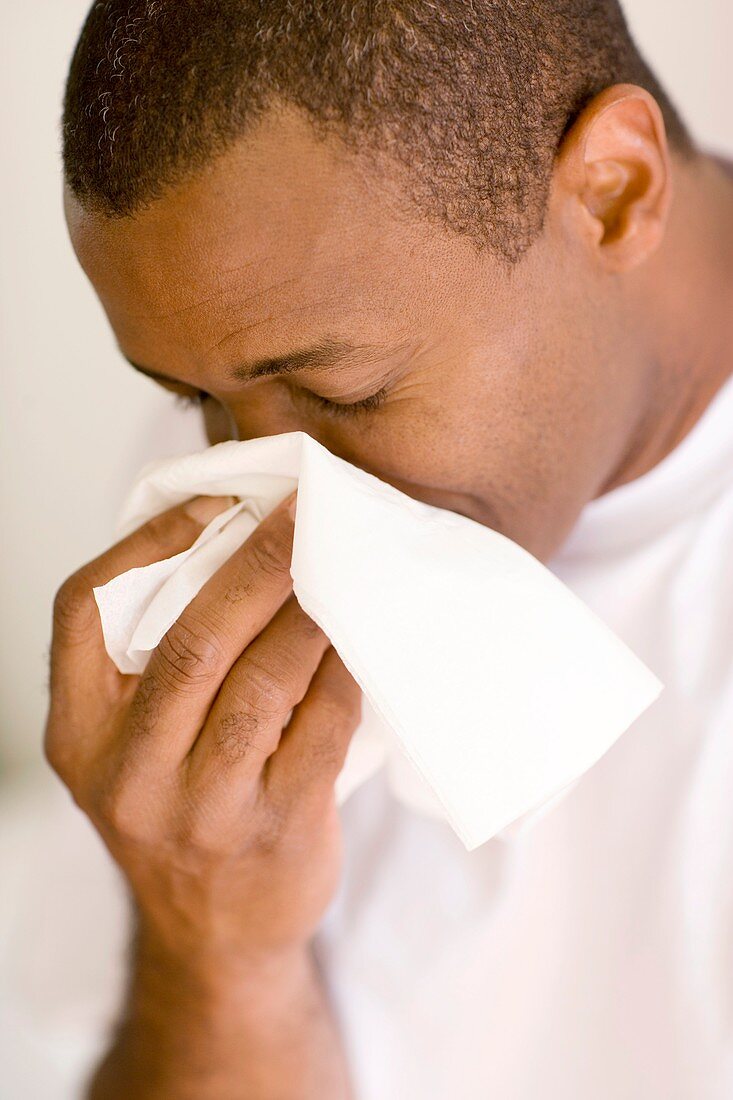 Man blowing his nose