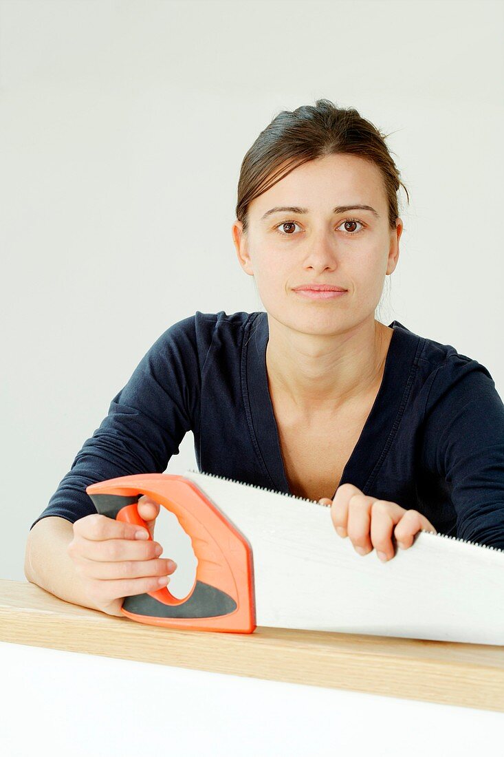 Woman holding a saw