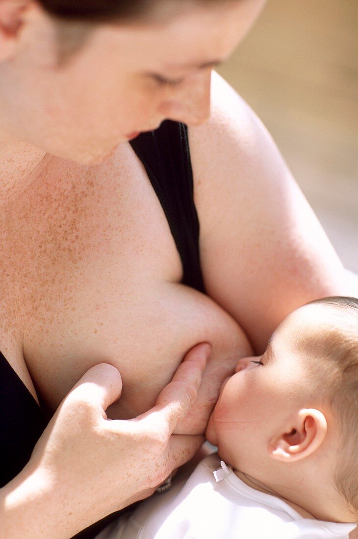 Mother breastfeeding baby girl