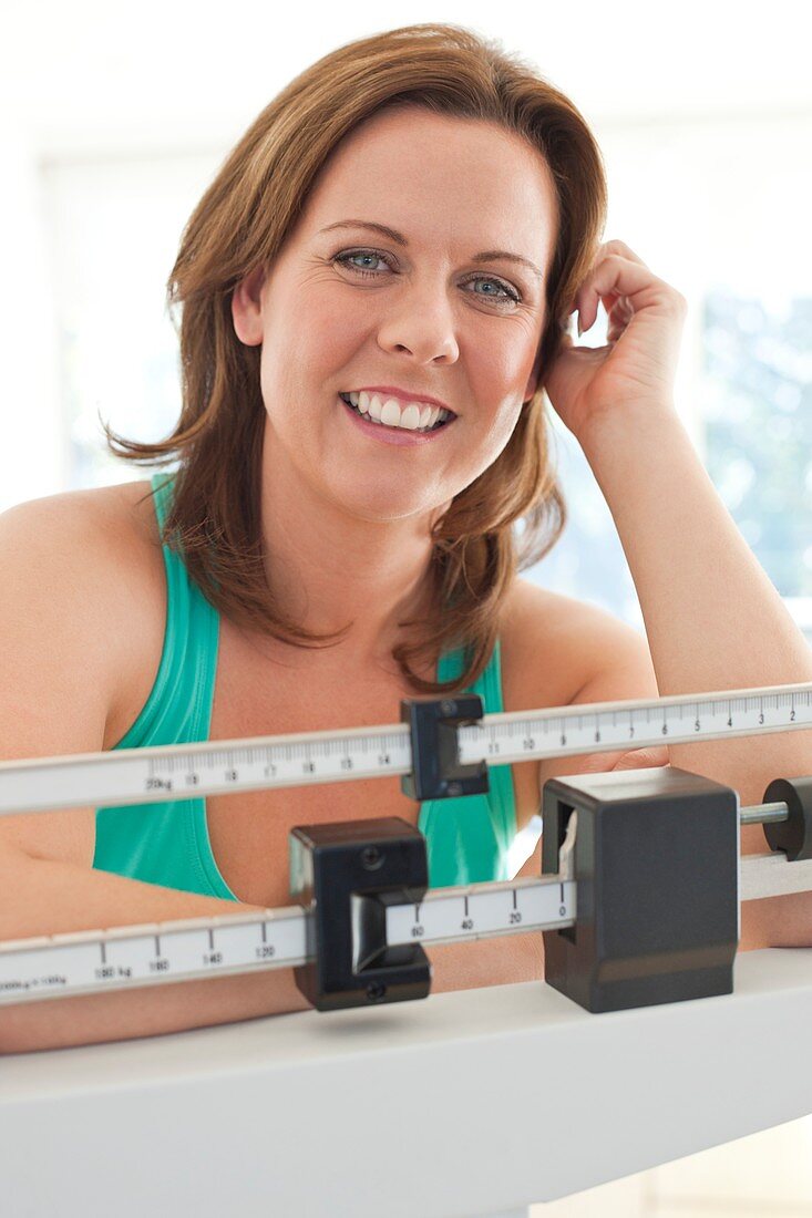 Woman weighing herself