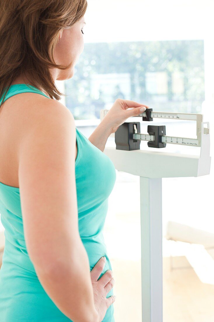 Woman weighing herself