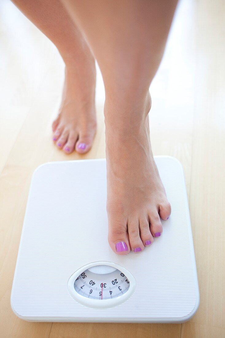 Woman weighing herself