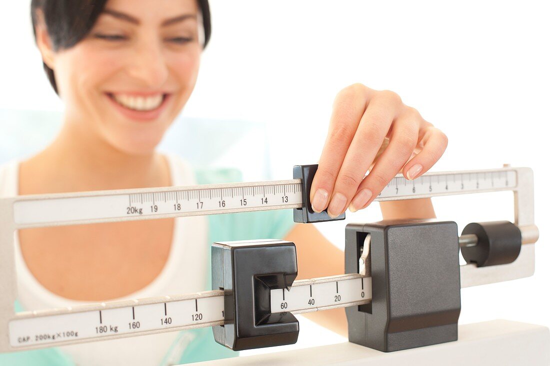 Woman weighing herself