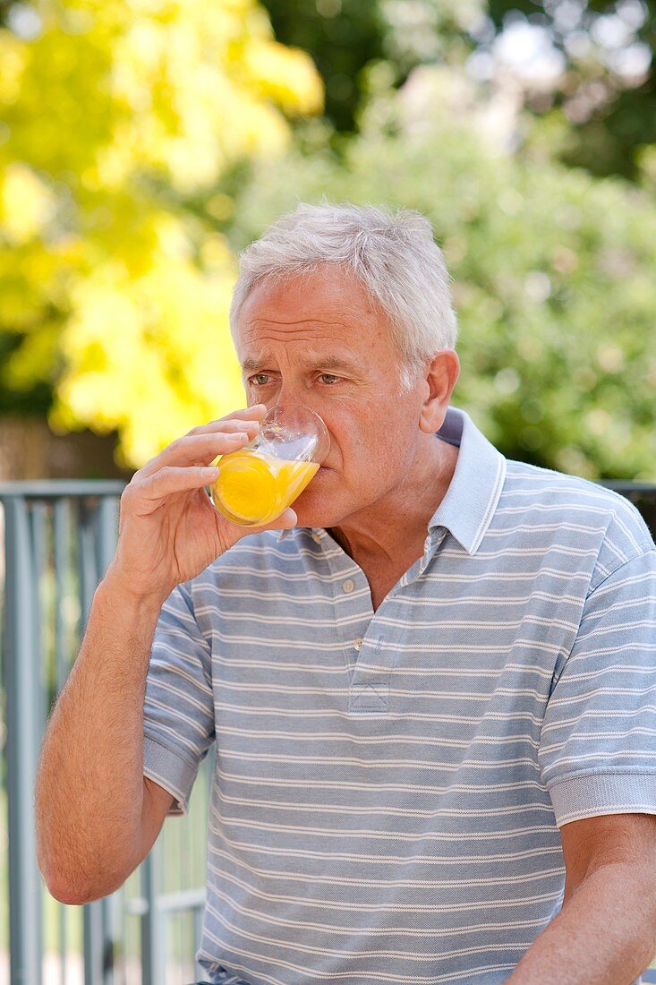 Diabetic man drinking a glucose drink