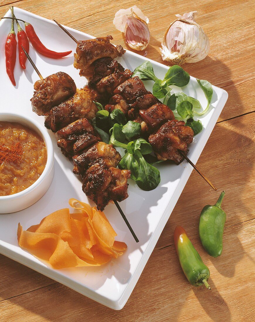 Grilled meat kebabs with spicy sauce