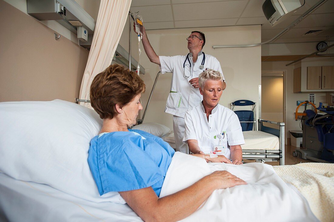 Nurses preparing a patient for an IV line