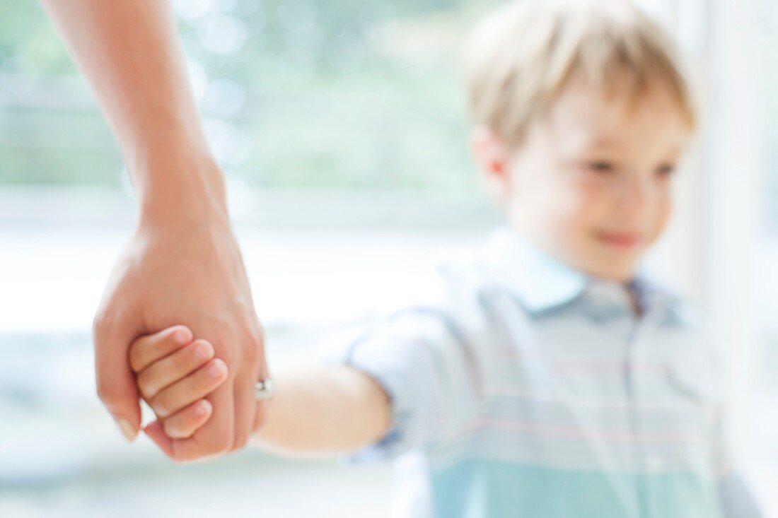 Mother and son holding hands