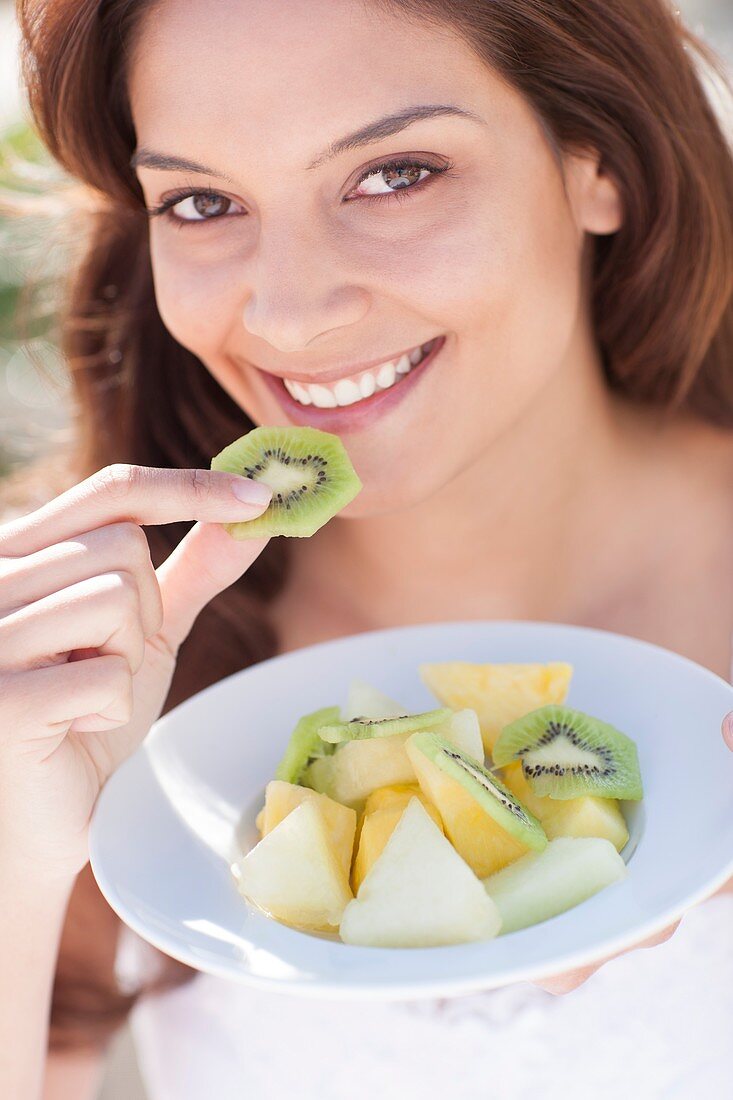 Woman eating fruit