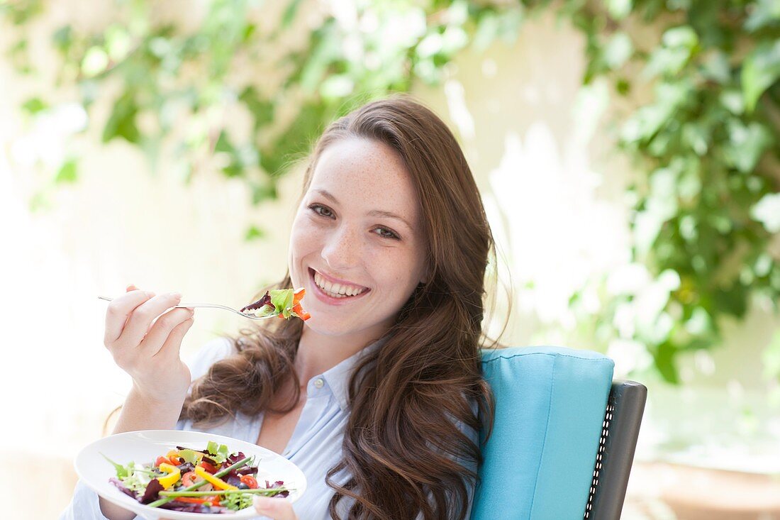 Young woman eating a salad