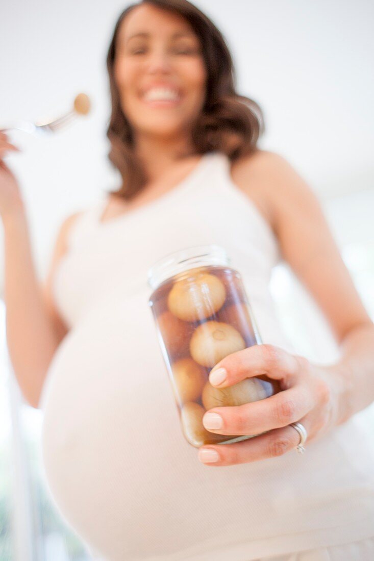 Pregnant woman eating pickled onions