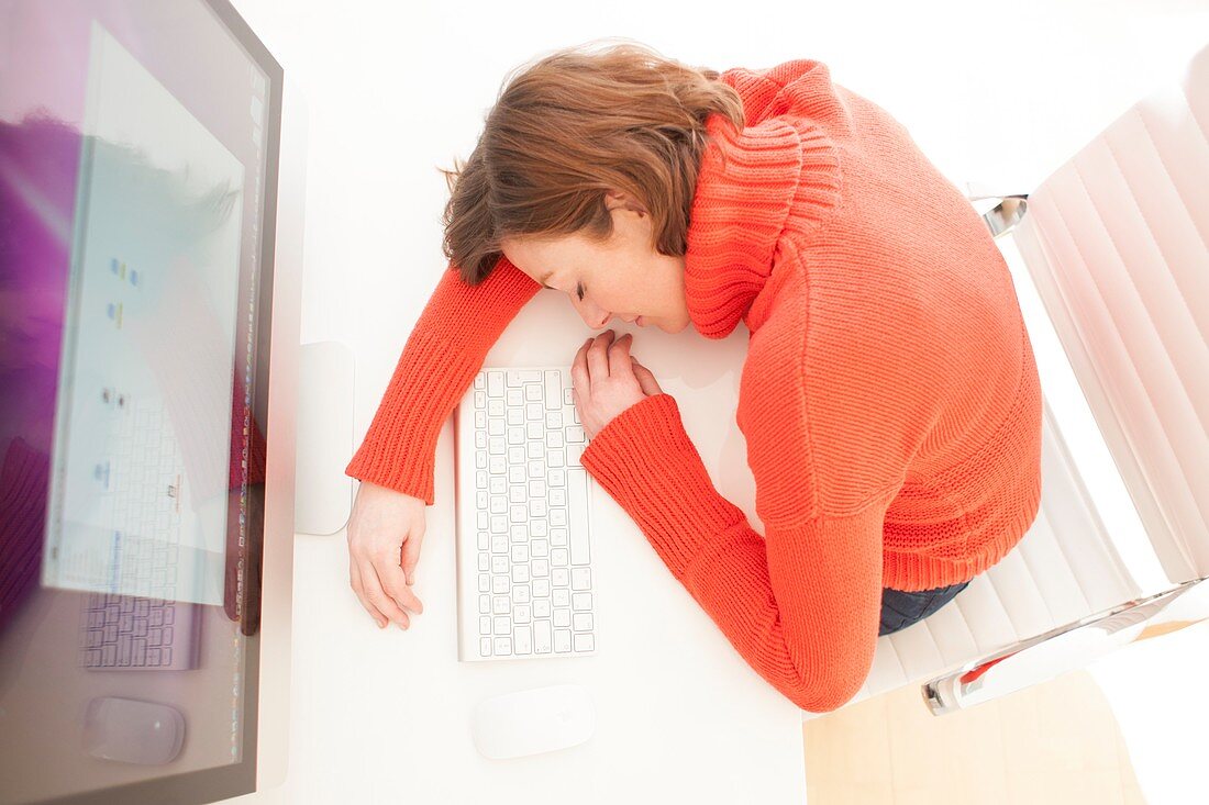 Woman asleep on keyboard