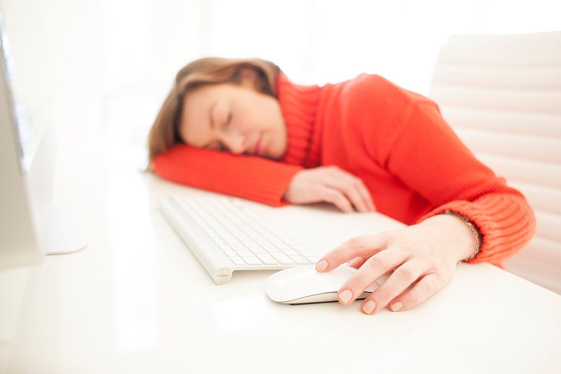 Woman asleep on keyboard