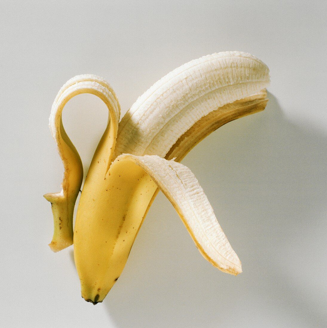 One Partially Peeled Banana