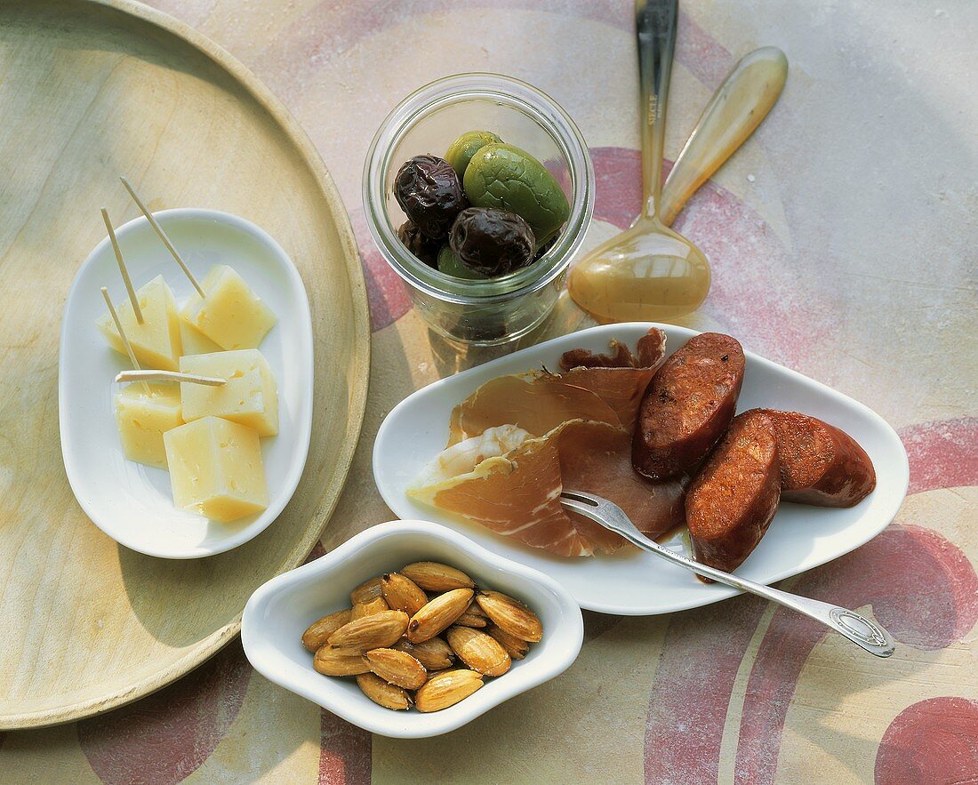 Tapas: cheese, salted almonds, olives, ham and chorizo