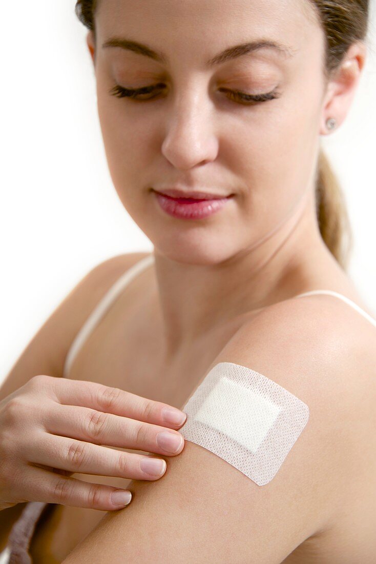 Teenage girl applying plaster