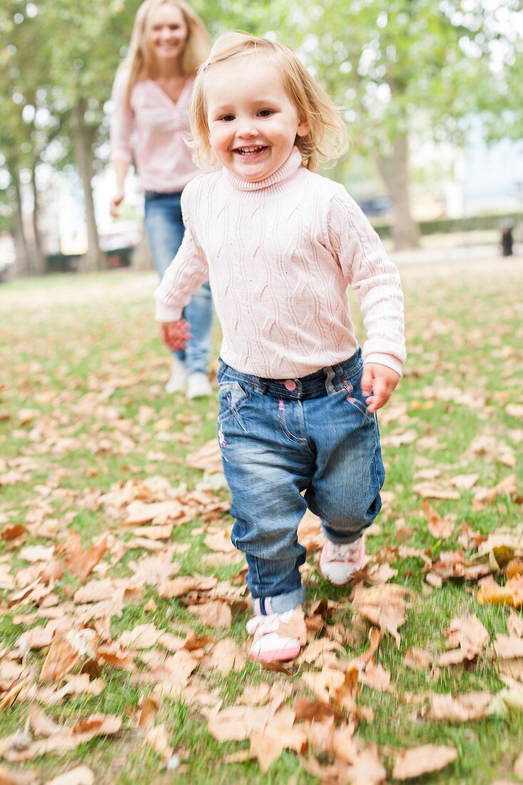 Young girl running in the leaves