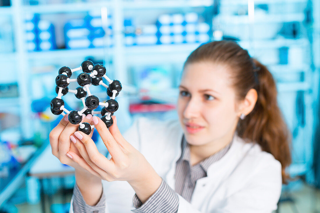 Lab assistant holding molecular model