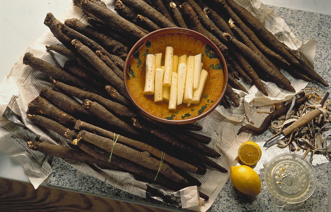 Lots of scorzonera, peeled and unpeeled in bowl