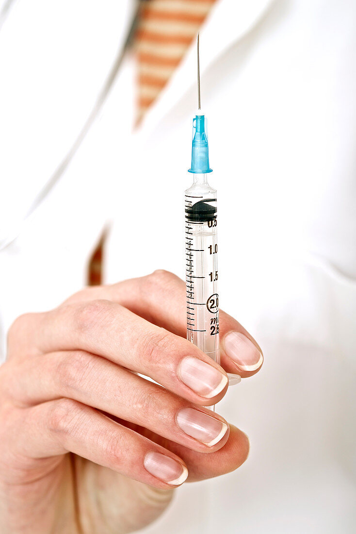 Person holding a syringe